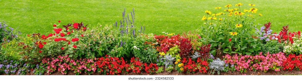 Natural flower bed in the park. Lots of beautiful summer flowers. Lush bright flowering in the garden. Banner. Multicolor blooming front garden. Outdoor summer gardening. - Shutterstock ID 2324582533
