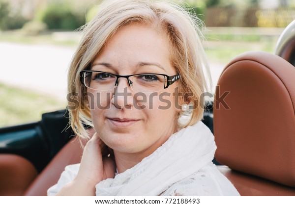 Natural forty\
years old woman in cabriolet\
car