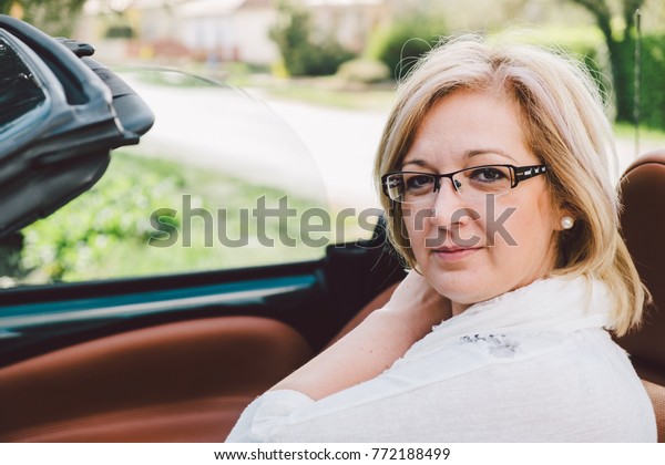 Natural forty
years old woman in cabriolet
car
