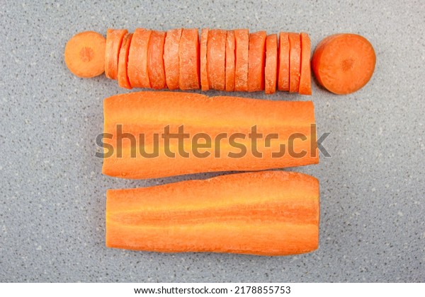 The Natural\
fresh carrots divided into pieces. Sliced carrots on the table\
design. Ripe carrot product\
ingredient.
