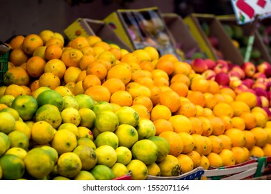 Natural fresh limes and oranges at the fruit and vegetable market