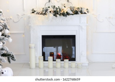 Natural Gas Fireplace Decorated With Christmas Ornaments, Candles And Basket Of Dried Pine Cones For The Holiday Season