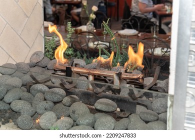 Natural Gas Fireplace Has Soothing Flame Buring Over A Bed Of Rocks In Dining Area.