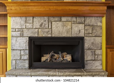 Natural Gas Insert Fireplace built with stone and wood