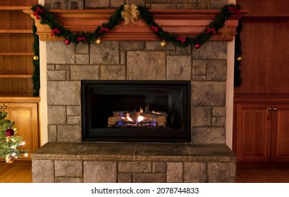 Natural Gas Insert Fireplace, Ceramic Logs, Decorated For A Merry Christmas Or A Happy New Year Concept 