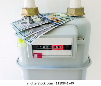 Natural Gas Meter With US Dollars Banknotes At Home. Symbolic Image For Heating Costs, Increased Gas Prices.