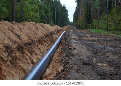 Natural gas pipeline construction work. A dug trench in the ground for the installation and installation of industrial gas and oil pipes. Underground work project. Small sharpness, granularity