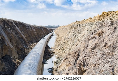 Natural Gas Pipeline Construction Work. A Dug Trench In The Ground For The Installation And Installation Of Industrial Gas And Oil Pipes. Underground Work Project