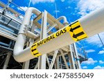 Natural gas pipeline with high pressure and direction sign at compressor station. Concept of energy transportation infrastructure