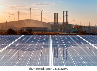 Natural Gas Processing Plant With Renewable Energy Wind Turbines Generating Electricity Reflection To Solar Panels At Sunset - Industrial Concept 