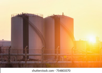 Natural Gas Storage Tanks And Oil Tank In The Petroleum Plant At Sunset