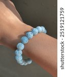 Natural gemstone bracelet on wrist under sunlight larimar