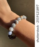 Natural gemstone bracelet on wrist under sunlight kyanite