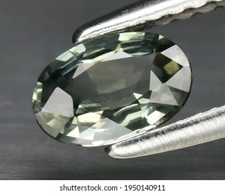 Natural Gemstone Green Sapphire On Gray Background