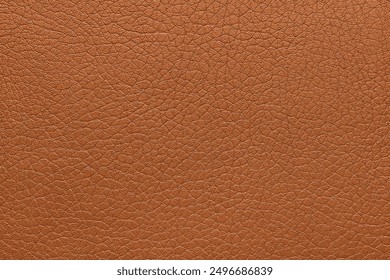 Natural, genuine orange leather texture close up, macro. Structure of glossy leatherette, artifical skin surface with embossing pattern. Background, wallpaper, backdrop