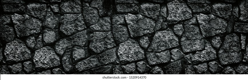 Natural Granite Stone Wall Wide Texture. Dark Rock Masonry Widescreen Gloomy Gothic Background