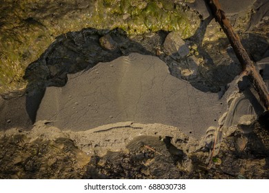 Natural Graphics On A Sand Beach Beside A River, Looks Like A Sinkhole Or An Aerial Image