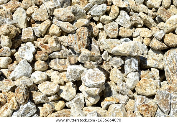 Natural gray gypsum
stones. Gypsum stone is a soft sulfate mineral composed of calcium
sulfate dihydrate. Industrial mining area. Limestone quarry with 
crystals of selenite. 