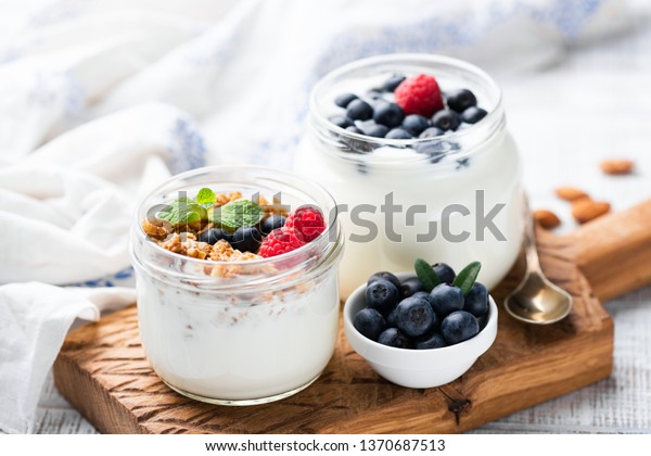 Natural Greek Yogurt With Fresh Berries And\
Granola In Jar. Healthy Eating, Healthy Lifestyle, Sporty Fitness\
Food Menu Concept