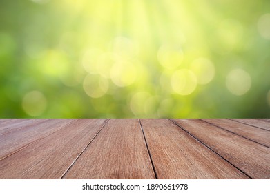 Natural Green Background With Selective Focus. The Green Background Has A Bokeh Leaf And Grass On A White Wooden Floor.