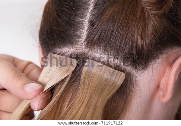 Natural\
Hair extensions at salon, closeup hands in\
hair