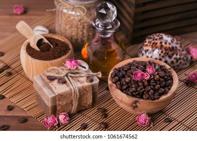 Natural handmade soap, aromatic cosmetic oil, sea salt with coffee beans on rustic wooden background. Healthy skin care. Sauna and SPA concept.