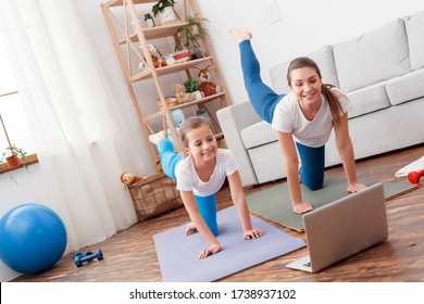 Natural Healthy Girls Women Doing Exercise On Yoga Mat At Home, Pilates, Stretching. Repeat Sports Movements For Online Lady Mentor Trainer On Laptop. Fitness Program Funny Enjoy Makes Feel Positive.