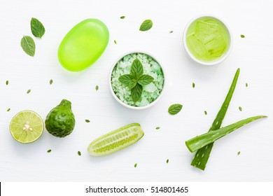 Natural herbal skin care products, top view ingredients. Cosmetic, soap, sea salt, herbs, mint leaf, cucumber, aloe vera,gel. Facial treatment preparation background.

