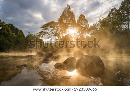 Natural hot spring mineral water with steam in Chae Son National Park in the morning, Lampang, Thailand.