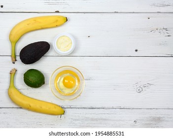 Natural Ingredients For Smoothing, Softening And Hydrating Your Hair. Avocado, Banana, Yogurt, Shea Butter And  Egg Yolk For Hair Mask. Flat Lay, Copy Space.