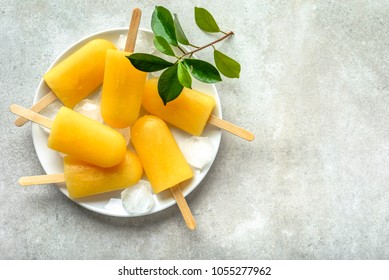 Natural juicy orange popsicles. Refreshing ice pops, overhead, flat lay