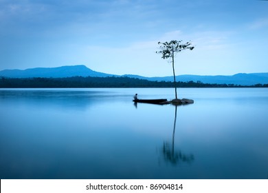 Natural Landscape In Blue. A Boat Floating In Smooth Water At Tranquil Lake .Many Traveller Come For Relaxing After Hard Working. This A Beautiful Gift From The Nature  