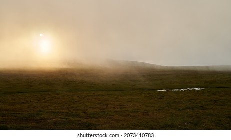 A natural landscape of a foggy sunset at Nordkapp, Norway