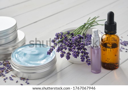 Natural lavender cream, bunch of lavender flowers, dropper bottle of essential lavender oil and perfumed water or hydrolate in a spray bottle.