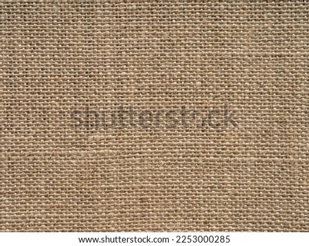 Natural light brown vintage linen canvas fabric texture. Stained, dirty, distressed material for making artwork, painting, designs decoration, background concepts, text, lettering, wall screen saver.
