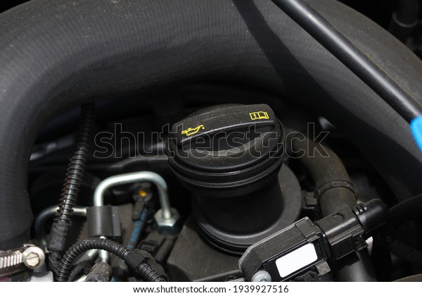 Natural light. the car. Engine\
compartment. Low depth of field. The neck for filling the\
oil