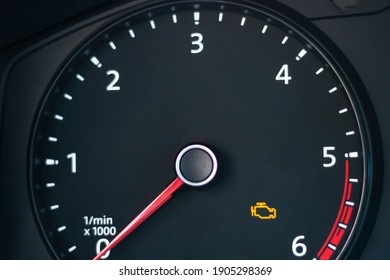 Natural light. the dashboard of the car. The engine error indicator lights up on it. Close-up