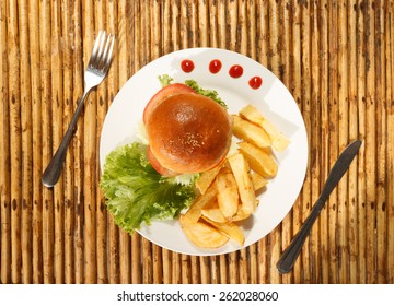 Natural Light Photo Of Chicken Burger And French Fries On Plate With Tableware Top View