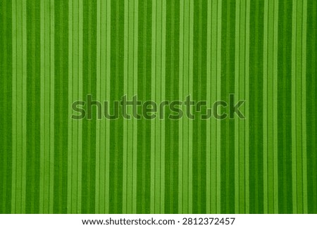 Natural linen texture as background. Cotton fabric with green  line striped pattern, texture close up. Backdrop, wallpaper. Material for clothes, blanket curtain upholstery