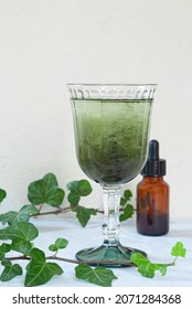 Natural Liquid Chlorophyll. Chlorophyll Drops In A Glass Of Water