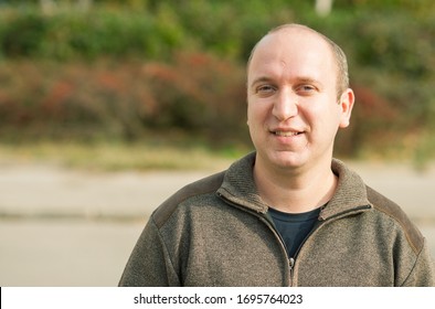 Natural looking guy with blue eyes smiling, portrait  - Shutterstock ID 1695764023