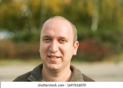 Natural looking guy with blue eyes smiling, portrait  - Shutterstock ID 1697616070