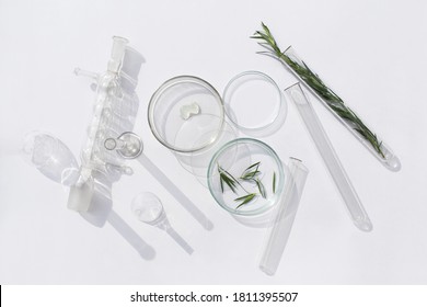 Natural medicine, cosmetic research, bio science, organic skin care products. Serum glass bottle with pipette in petri dish on white background. Top view, flat lay. Concept skincare. Dermatology