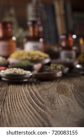 Natural medicine. Shallow depth of focus. Wooden table. Herbs, berries and flowers in bowls. Beautiful bokeh. - Shutterstock ID 720083155