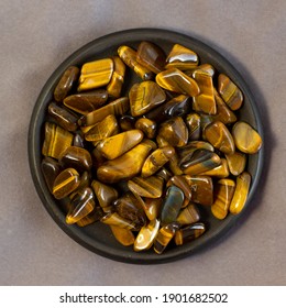 Natural Mineral Gem Stone Tiger's Eye Tigers Eye, Tiger Eye Gemstone On Grey Cloth Background Close Up