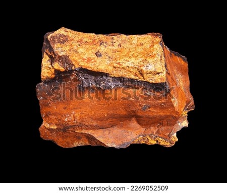 Natural mineral rock specimen - limonite stone isolated on black background. Close-up limonite (laɪmənaɪt) iron ore.