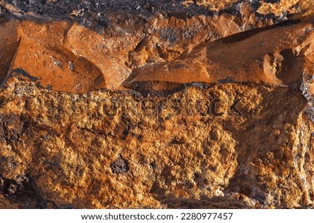 Natural mineral rock specimen - limonite stone surface as a background. Close-up limonite (laɪmənaɪt) iron ore