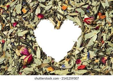 Natural mix herbal and green tea with goji berries, eucalyptus leaves, orange peel, flowers petals on white background. Heart shaped. Top view. Close up. High resolution