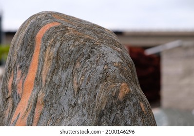 Natural Monolith Stone Coral And Gray Colors On The Building Background. Decorative Stones For Design.