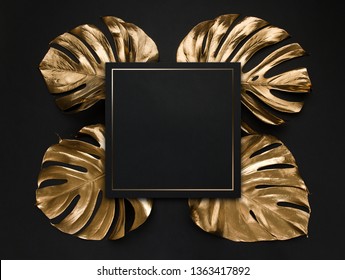 Natural monstera leaves spray painted with golden metallic paint on dark deep black background. Trendy layout border frame wtih blank card as coopy space. Creative luxury cover, invitaion template. - Powered by Shutterstock